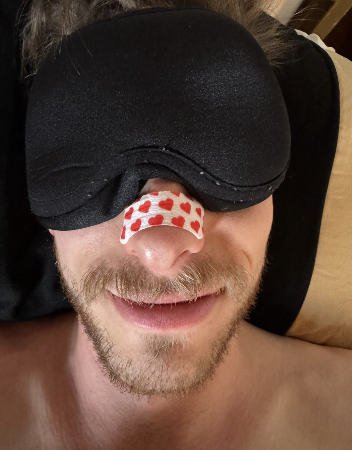 Pretty Ugly customer wearing nose tape with a sleep mask
