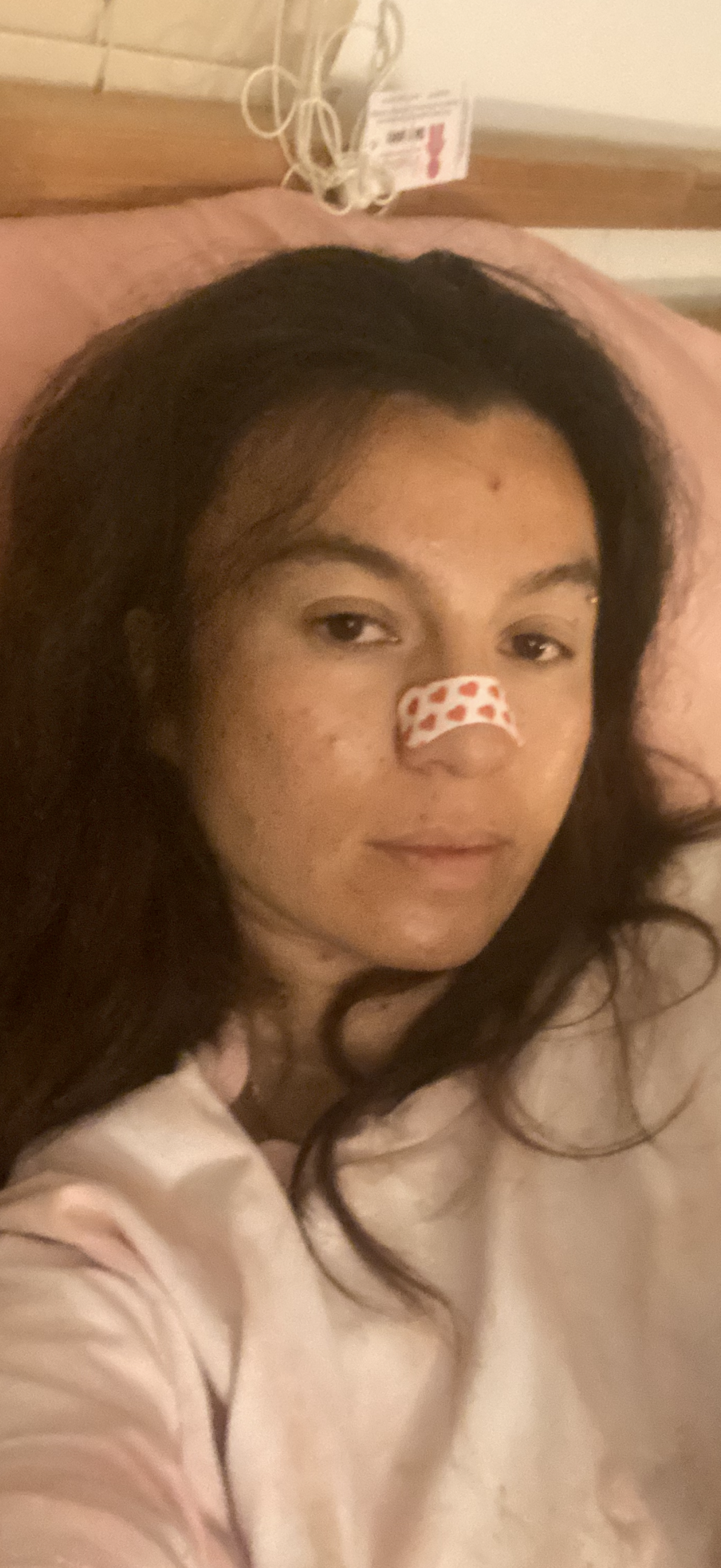 Pretty Ugly customer wearing nose tape in bed